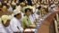 Burma's opposition leader Aung San Suu Kyi, third from left, takes a seat for a regular session of Parliament at Burma's Lower House in Naypyitaw, July 9, 2012.