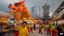 FILE - Traditional dragon dances are performed at a temple during the eve of Nine Emperor Gods festival in Kuala Lumpur, Malaysia, Oct. 2, 2024.