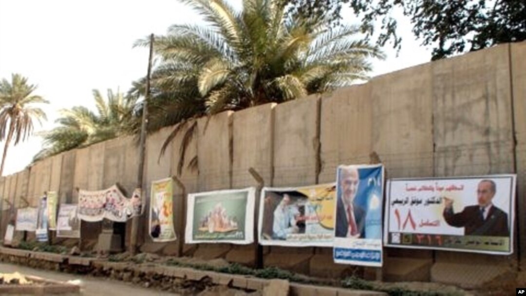 Campaign posters line a concrete blast wall in Baghdad ahead of Sunday's national elections, 06 Mar 2010
