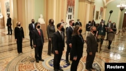 House impeachment managers stand at the U.S. Capitol to hand-carry an article of impeachment against former President Donald Trump to the Senate for trial.