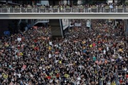 FILE - Protesters take part in a rally in Hong Kong, July 1, 2019.
