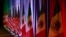 FILE - From left, the national flags of Canada, the U.S. and Mexico are illuminated by stage lights ahead of a news conference at the start of trilateral trade talks in Washington, Aug. 16, 2017. 