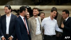 French newly-elected Member of Parliament (MP) for La France Insoumise (LFI) from the leftist coalition "Nouveau Front Populaire" (New Popular Front - NFP) Raphael Arnault (C) and colleagues arrive to the France's National Assembly in Paris on July 9, 202