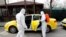 Municipality workers wearing protective suits sanitise a taxi in Karaagac district against the coronavirus disease (COVID-19) near Turkey's Pazarkule border crossing with Greece's Kastanies, in Edirne, Turkey, March 10, 2020. 