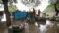 A man drags a trunk to higher ground after floodwaters inundated homes along the banks of the Yamuna River, in New Delhi, India, June 19, 2013.