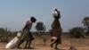 FILE - Women carry food at a food distribution site in Nyal, Unity State. More than one million people have been forced from their homes by the conflict, of which 803,200 have been displaced within South Sudan and 254,600 have fled to neighbouring countr