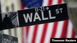 A Wall Street sign is pictured outside the New York Stock Exchange, in New York City