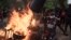 A demonstrator walks past a barricade set on fire during a protest in support of main opposition leader Ousmane Sonko in Dakar, Senegal, May 29, 2023. 