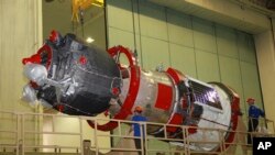 FILE - In this photo taken July 28, 2019, and distributed by the Roscosmos Space Agency Press Service, a Soyuz MS-14 capsule is being prepared for launch at Russia's space facility in Baikonur, Kazakhstan.