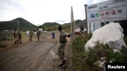 Security guards keep watch at the entrance of the Lily mine, which is owned by Vantage Goldfields, near Barberton, east of Johannesburg, Feb. 5, 2016.