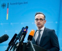 FILE - German Foreign Minister Heiko Maas briefs the media during a news conference on current developments in the worldwide spread of the coronavirus at the foreign ministry in Berlin, March 17, 2020.