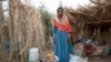 Ethiopian Tigrayan refugee 27-year-old Aksamaweet Garazgerer, who is living with HIV, stands in front of her temporary shelter at Umm Rakouba refugee camp in Qadarif, eastern Sudan, Dec. 7, 2020. 