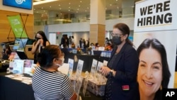 La reclutadora de recursos humanos de Marriot, Mariela Cuevas, izquierda, habla con Lisbert Oliveros en una feria laboral en el Hard Rock Stadium en Miami Gardens, Florida, el 3 de septiembre del 2021. 