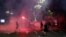 Protesters clash with riot police on the steps of the Serbian parliament during a protest in Belgrade, Serbia, July 10 2020.