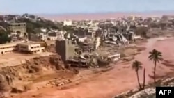 This image grab from footage published on social networks by Libyan al-Masar television channel on September 13 shows an aerial view of a extensive damage in the wake of floods after the Mediterranean storm "Daniel" hit Libya's eastern city of Derna.