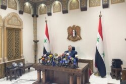 Parliament Speaker Hammouda Sabbagh announces the results of the Syrian presidential election at the Syrian parliament building in Damascus, Syria, May 27, 2021.