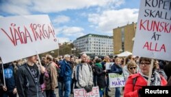 Demonstrators hold placards during the "March for Science Stockholm" manifestation at Medborgarplatsen square in Stockholm, Sweden April 22, 2107.