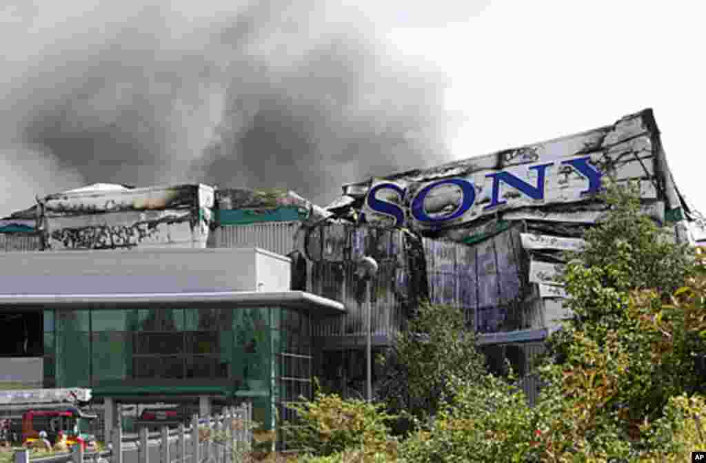 Smoke rises from a burning Sony distribution center reportedly set alight by rioters in Enfield, London, August 9, 2011