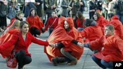 Romanian volunteers hold their hands forming a red ribbon, the anti-AIDS symbol, during an awareness rally two days before World AIDS day, in central Bucharest, Romania, November 29, 2011.