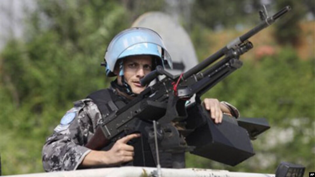 UN forces patrol outside the UN headquarters in Ivory Coast, Abidjan, Ivory Coast, Tuesday, Dec. 21, 2010.