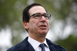 FILE - Treasury Secretary Steve Mnuchin speaks with reporters about economic impacts of the coronavirus outside the White House, March 29, 2020, in Washington.