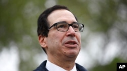 FILE - Treasury Secretary Steve Mnuchin speaks with reporters about economic impacts of the coronavirus outside the White House, March 29, 2020, in Washington. 