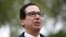FILE - Treasury Secretary Steve Mnuchin speaks with reporters about economic impacts of the coronavirus outside the White House, March 29, 2020, in Washington. 