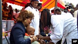 Newly re-elected president Blaise Compaore's wife Chantal holds a young boy during the launch of a new vaccination campaign against meningitis in Ouagadougou, Burkina Faso, 06 Dec. 2010