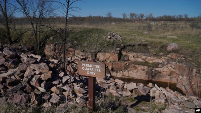 Piles of broken quartzite surround the quarries where the sacred pipestone, used to carve pipes for indigenous ritual and ceremonies, is chiseled and broken free by those enrolled in a federally recognized tribe, on Tuesday, May 2, 2023, in Pipestone, Minn. (AP Photo/Jessie Wardarski)