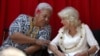 Britain's Queen Camilla talks with Prime Minister of Samoa Naomi Fiame Mataafa during the Commonwealth Heads of Government Meeting Women's Forum side-event in Apia on October 24, 2024.