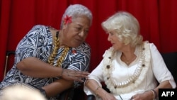 Britain's Queen Camilla talks with Prime Minister of Samoa Naomi Fiame Mataafa during the Commonwealth Heads of Government Meeting Women's Forum side-event in Apia on October 24, 2024.