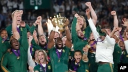 South African captain Siya Kolisi holds the Webb Ellis Cup aloft after South Africa defeated England to win the Rugby World Cup final at International Yokohama Stadium in Yokohama, Japan, Nov. 2, 2019.