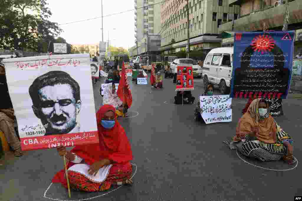 Labour union workers maintain social distancing as they carry placards during a May Day rally in Karachi, Pakistan.