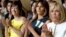 Amelie Derbaudrenghien, the partner of Belgian Prime Minister Charles Michel, left, U.S. first lady Melania Trump, center, and French first lady Brigitte Macron applaud during at the Queen Elisabeth Music Chapel in Waterloo, Belgium, July 11, 2018.