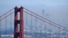 The San Francisco skyline is obscured by smoke from wildfires, as the Golden Gate Bridge rises in the foreground, Aug. 19, 2020, in this view from the Marin Headlands near Sausalito, Calif.