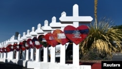 A cross for each of the victims waits to be taken to a growing memorial site two days after a mass shooting at a Walmart store in El Paso, Texas, Aug. 5, 2019. 