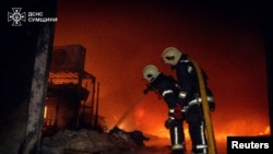 FILE - Firefighters work at the site of a warehouse hit by a Russian drone strike, amid Russia's attack on Ukraine, in Sumy, Ukraine, March 6, 2025. (Press service of the State Emergency Service of Ukraine in Sumy region/Handout via Reuters)