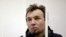 Greenpeace activist Tomasz Dziemianczuk of Poland looks out from a defendants' cage during a court session in St. Petersburg, Russia, Nov. 19, 2013.