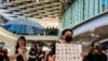 FILE - Pro-democracy protesters demonstrate in a shopping mall in the district of Yuen Long to mark the two-month anniversary of the attack that took place in the Yuen Long train station, Hong Kong, September 21, 2019.