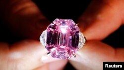 A Christie's staff holds a 18.96-carat Fancy Vivid Pink Diamond during a preview in Geneva, Nov. 8, 2018. 