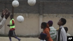 Children attend football training at a ground in Alexandra Township, north of Johannesburg on June 30, 2010. Memories of South Africa 2010 World Cup are fading fast, as its progress halted by a scandal-ridden period off the field since the historic tournament. 