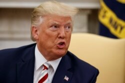 FILE - President Donald Trump speaks during a meeting in the Oval Office of the White House, Aug. 20, 2019.