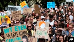 FILE - Activists march on Parliament to protest a lack of action on climate change, in Wellington, New Zealand, Sept. 27, 2019.