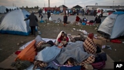 Pengungsi Afghanistan menyelimuti diri untuk berlindung dari dinginnya udara pagi di tempat penampungan sementara, di tempat parkir truk, perbatasan Hungaria-Austria dekat Nickelsdorf, Austria, 23 September 2015. (Foto: dok).