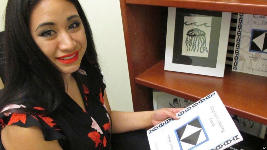 Britt'Nee Brower shows an Inupiat coloring book she published and she talks about the new Inupiat Eskimo language option now available for Facebook bookmarks, action buttons. Alaskans made the option a reality through the social media giant's community translation tool, Anchorage, Alaska, Aug. 23, 2018.
