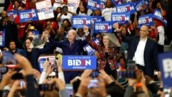 FILE - Sen. Kamala Harris, D-Calif., from left, Democratic presidential candidate former Vice President Joe Biden, Michigan Gov. Gretchen Whitmer, and Sen. Cory Booker D-N.J. greet the crowd during a campaign rally in Detroit, March 9, 2020.