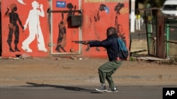 Metro police take aim on people who took part in a protest, at a shopping center in Soweto, near Johannesburg, South Africa, July 13, 2021.