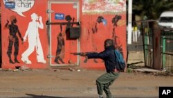 Metro police take aim on people who took part in a protest, at a shopping center in Soweto, near Johannesburg, South Africa, July 13, 2021.