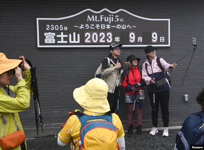 Visitors are seen at the fifth stage on the slopes of Mount Fuji, Japan's highest mountain 3,776 metres (12,388 ft), in Fujiyoshida, Japan on September 9, 2023. (REUTERS/Chris Gallagher)