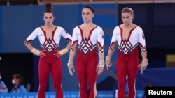 FILE - Germany's Kim Bui, Pauline Schaefer and Elisabeth Seitz compete in unitards in Tokyo, Japan, July 25, 2021.